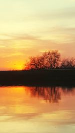 Scenic view of lake at sunset