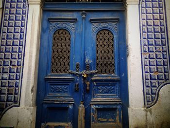 Closed old blue door locked with chain