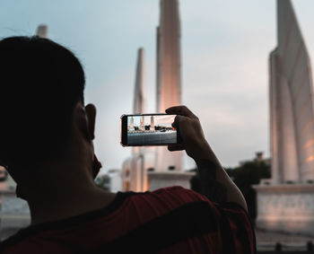 Rear view of man photographing