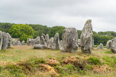 View of rocks on field against sky