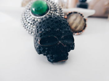 Skull shaped ring and personal accessory on table