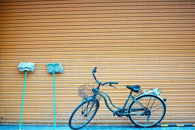 Bicycle parked on street by shutter