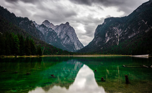 Scenic view of lake by mountains against sky