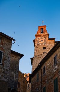 Low angle view of old building against blue sky