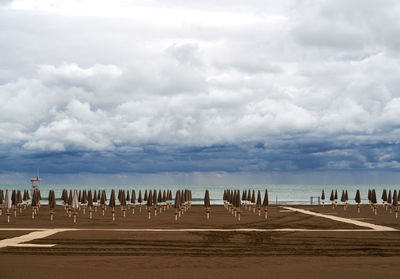 Scenic view of a empty beach against a cloudy sky