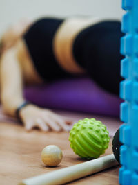 Defocused image of woman lying on exercise mat at gym