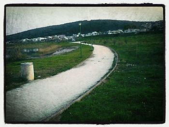 Road passing through field