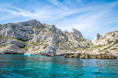 Scenic view of sea and mountain against sky