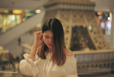 Woman looking down in shopping mall