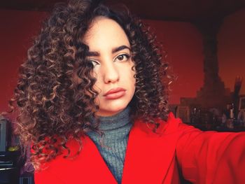 Close-up portrait of young woman with curly hair