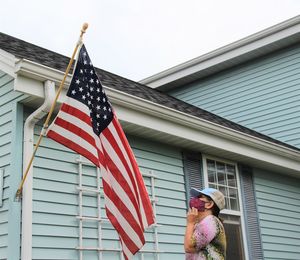 Low angle view of woman admiring united states flag