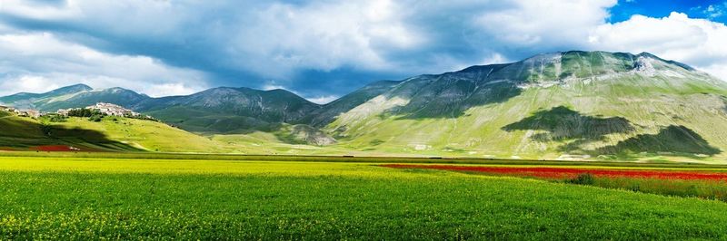 Scenic view of mountains against cloudy sky