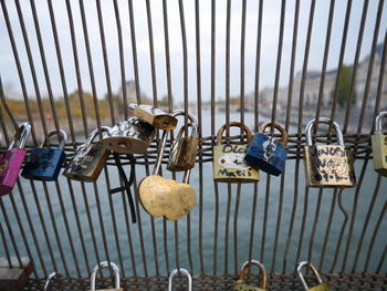 Close-up of padlocks hanging on railing