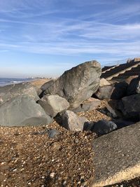 Rocks on beach against sky