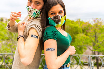 Portrait of young couple standing outdoors