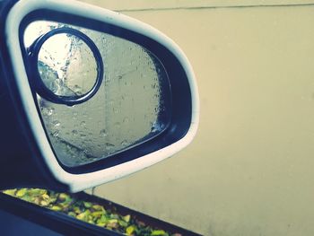 Close-up of water on side-view mirror