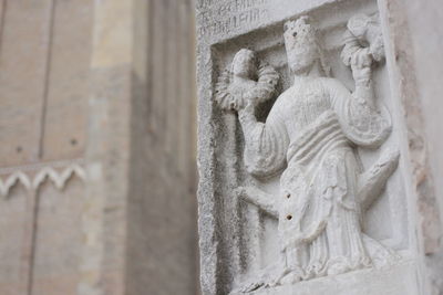 Close-up of sculpture on wall of building