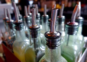 Close-up of alcohol bottles in box at bar