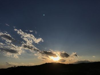 Scenic view of silhouette moon against sky during sunset