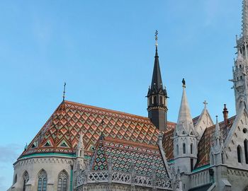 Low angle view of buildings against blue sky