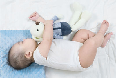 High angle view of baby lying on bed at home