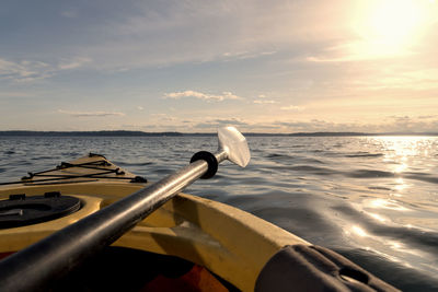 Boat on sea against sky during sunset