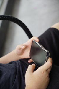 Midsection of woman using mobile phone