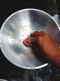 Close-up of man preparing food in plate