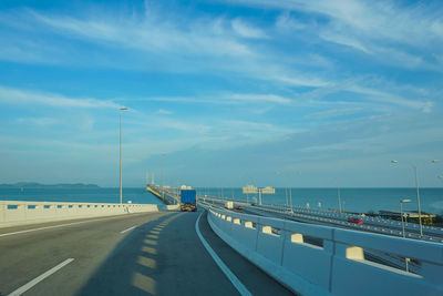 Vehicles on road against sky