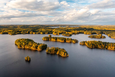 Autumn foliage colored trees, lake and islands in heinola, finland