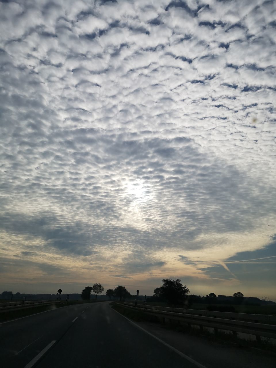 ROAD AGAINST CLOUDY SKY DURING SUNSET