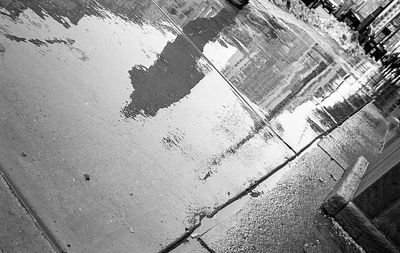 Reflection of building in puddle