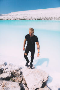 Full length of man standing on rock