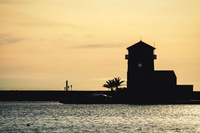 Silhouette of built structure at sunset