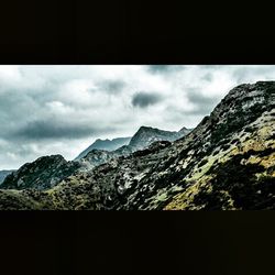 Scenic view of mountains against cloudy sky