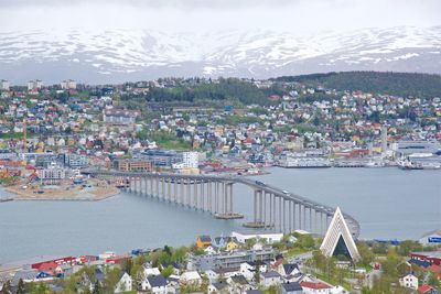 High angle view of city by river against sky