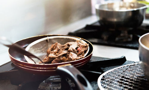 Close-up of meat in cooking pan on table