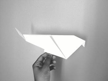 Close-up of hand holding paper origami