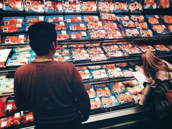 Rear view of woman standing at store