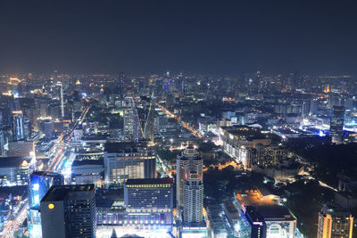 High angle view of illuminated city buildings at night