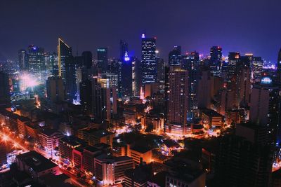 Aerial view of city lit up at night