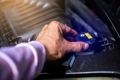 Cropped hand of man repairing car