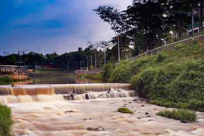 Scenic view of waterfall against sky