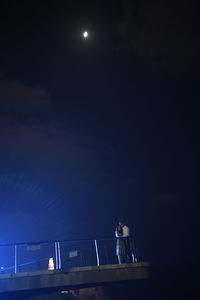 Low angle view of man standing at night
