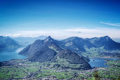 Scenic view of mountains against blue sky