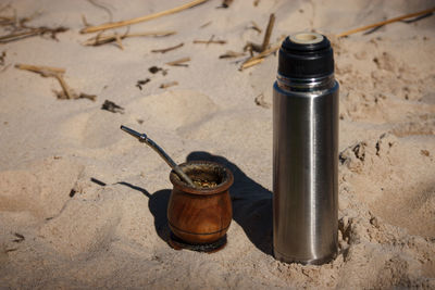 High angle view of bottle on sand at beach