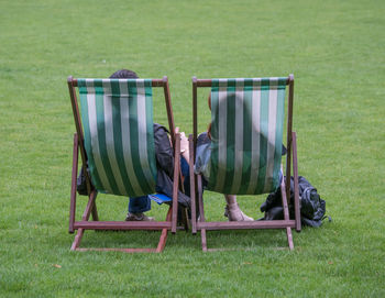 Chairs on wooden chair in green grass