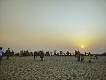 People on beach at sunset