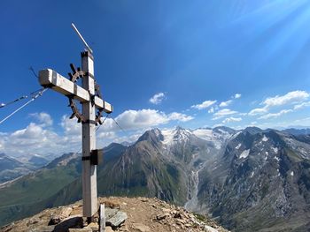 Windmill on snowcapped mountain against sky