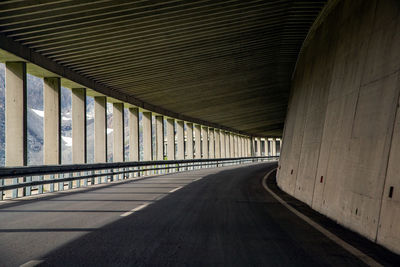 Empty road with bridge in background